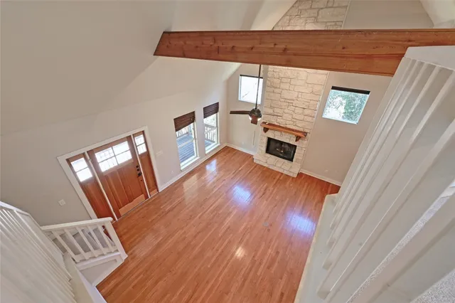 a view of a livingroom with wooden floor and stairs