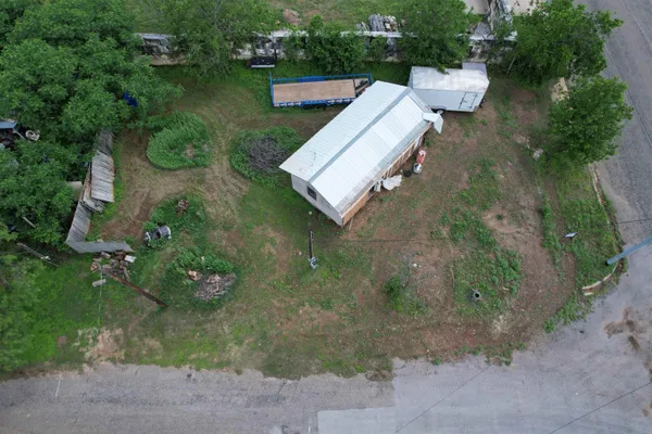 an aerial view of a house with a yard