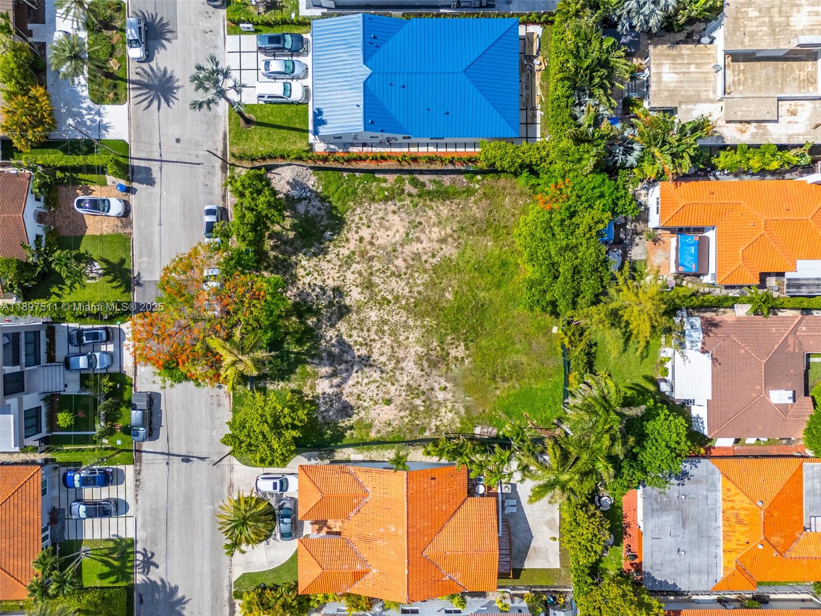 8835 Froude Avenue Surfside, FL 33154 - Photo 8 of 13 an aerial view of a house with a yard