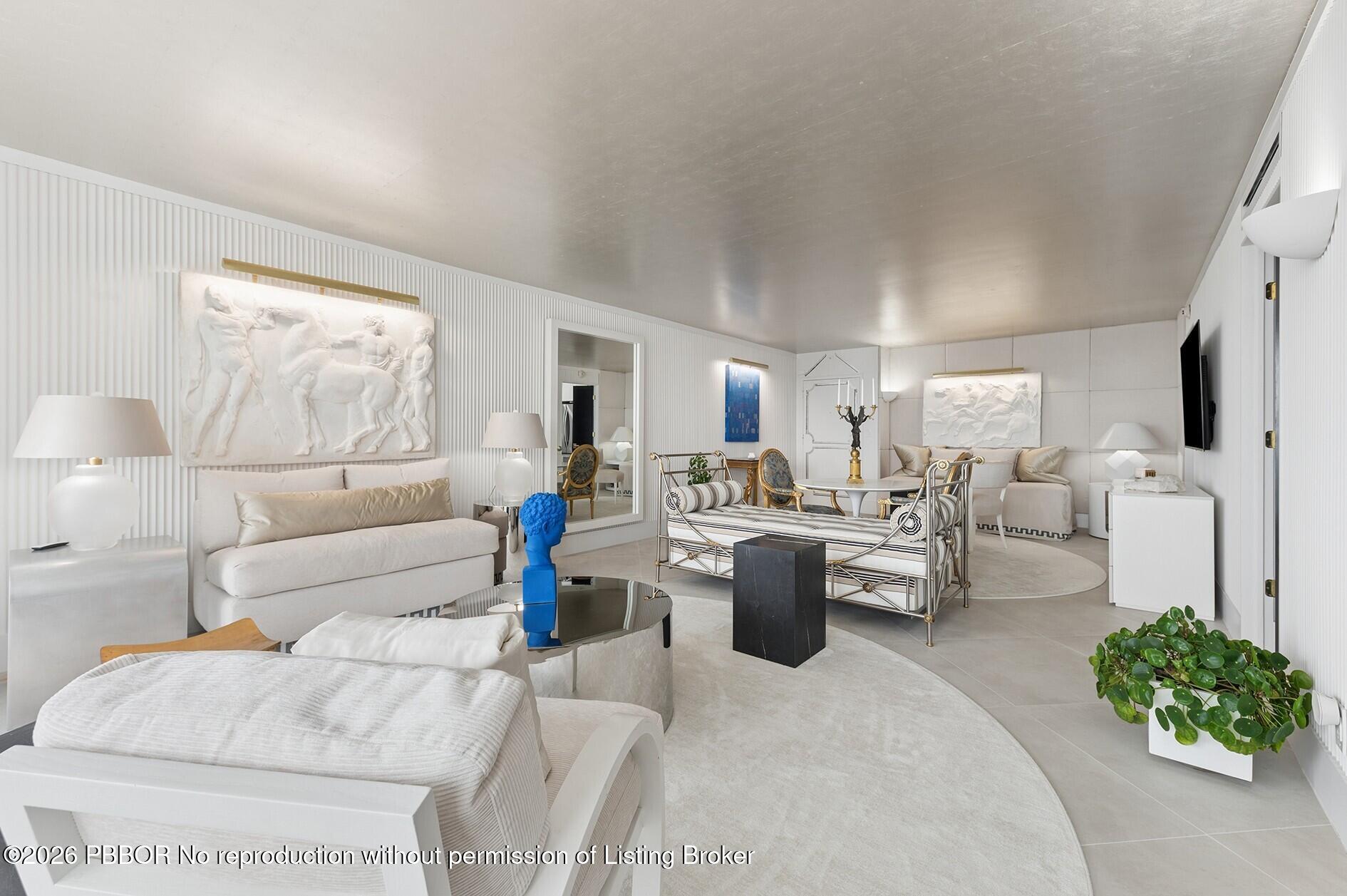 3800 Washington Road, Unit 909 West Palm Beach, FL 33405 - Photo 3 of 9 a living room with fireplace furniture and a large window