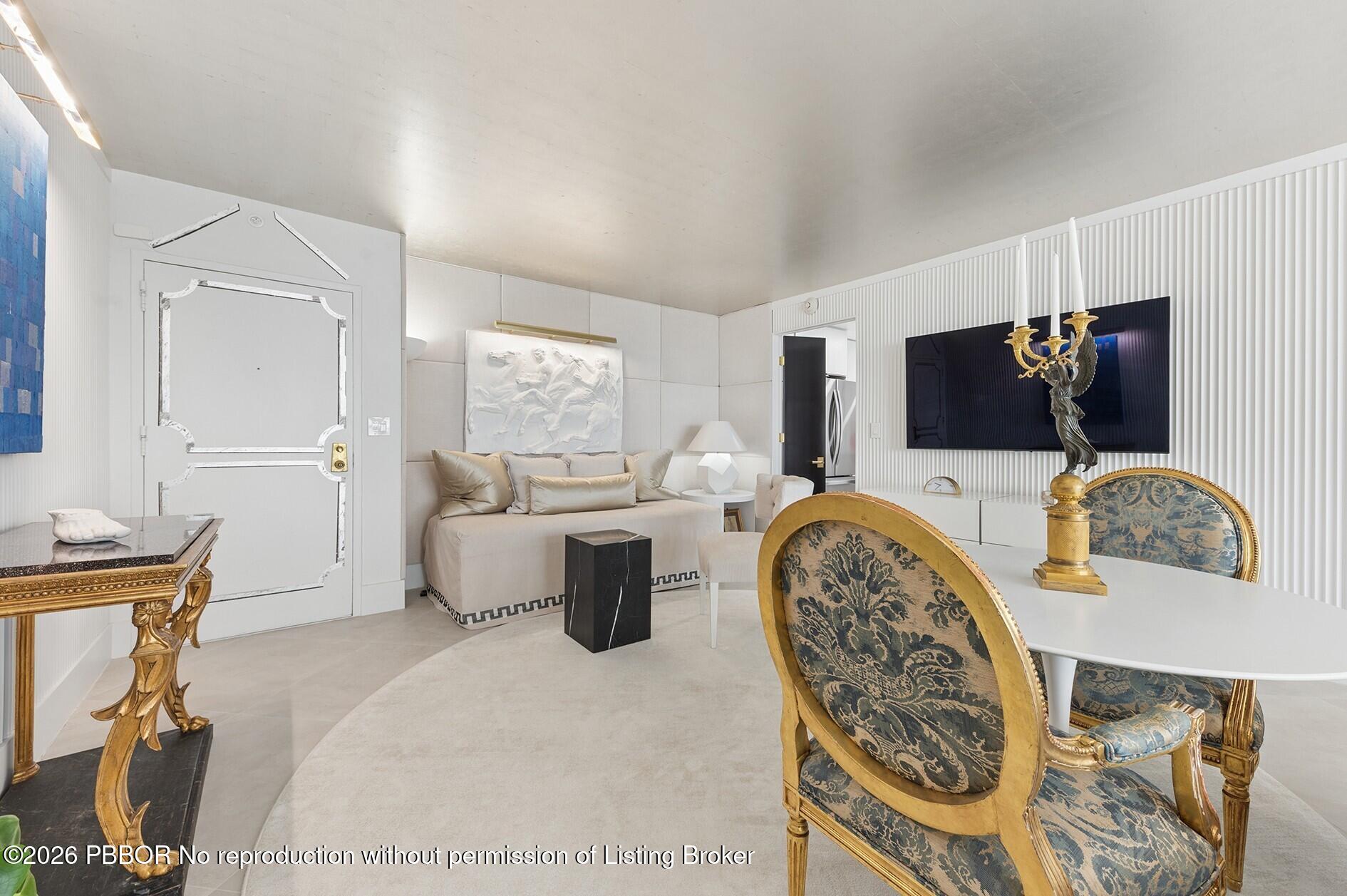 3800 Washington Road, Unit 909 West Palm Beach, FL 33405 - Photo 6 of 9 a bedroom with furniture and a flat screen tv