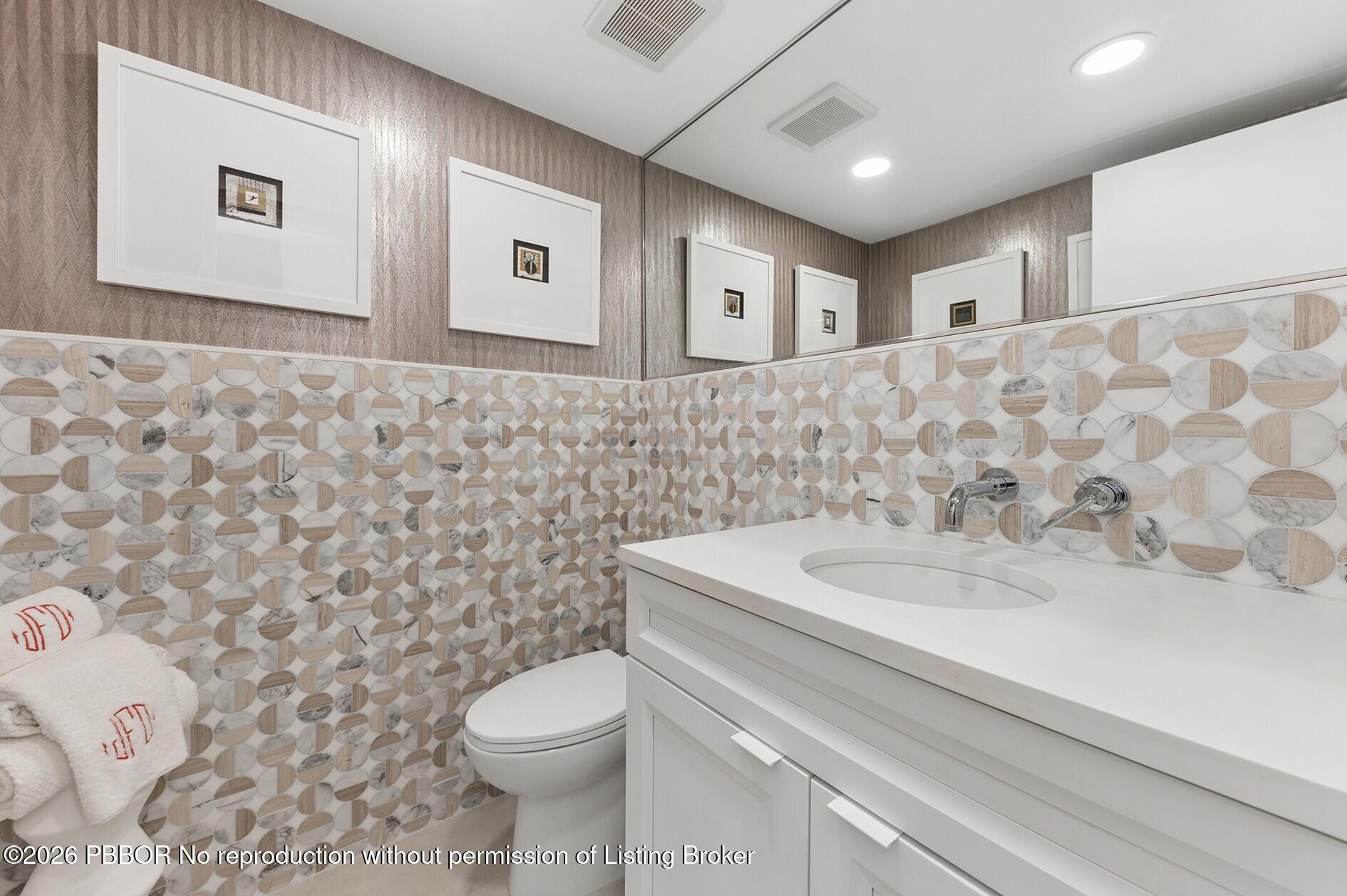 3800 Washington Road, Unit 909 West Palm Beach, FL 33405 - Photo 9 of 9 a bathroom with a sink a toilet and a mirror