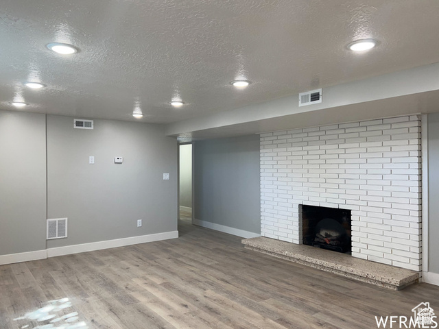 702 North 100 West Logan, UT 84321 - Photo 5 of 58 Unfurnished living room with visible vents and wood finished floors