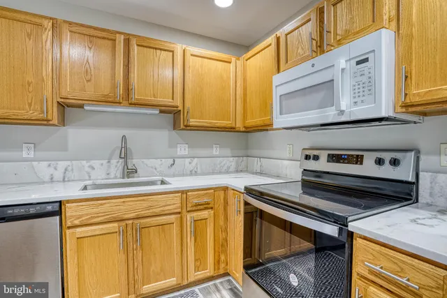 a kitchen with a table chairs sink and cabinets