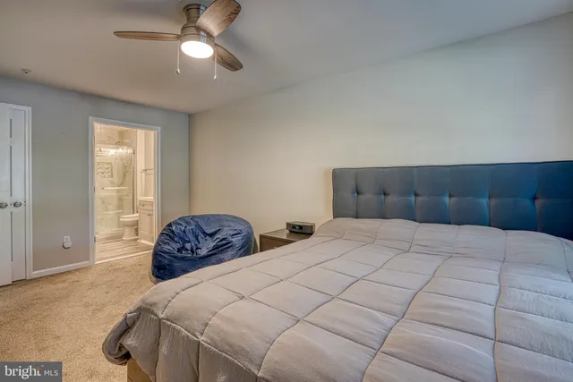 a bedroom with a large bed and a tv