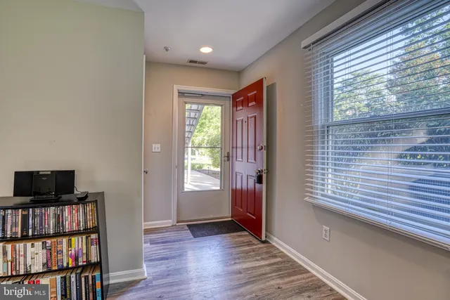 a view of a livingroom with an empty space and a window