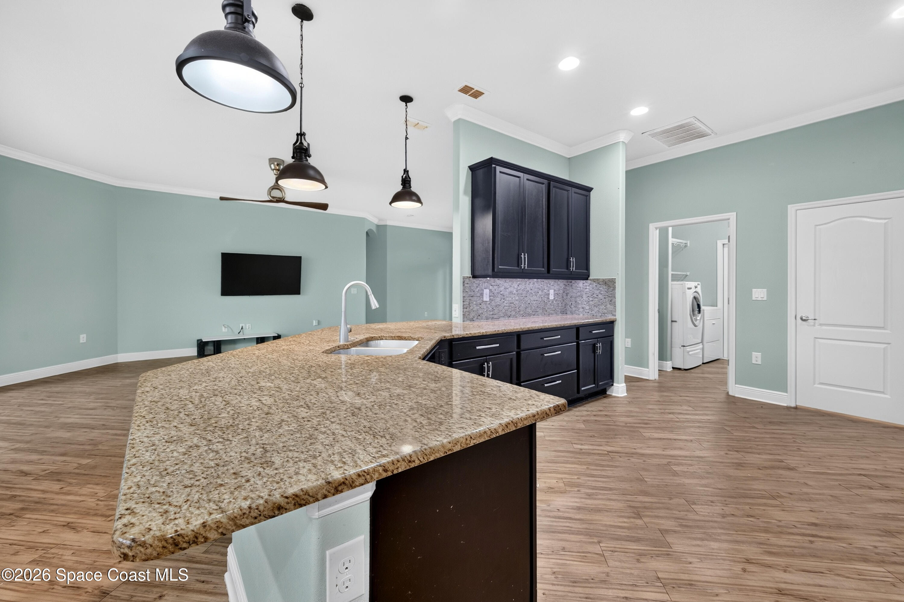 1475 Dalbora Road Merritt Island, FL 32953 - Photo 26 of 57 a kitchen with stainless steel appliances granite countertop a sink and a refrigerator
