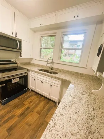 a kitchen with a stove a sink and a microwave