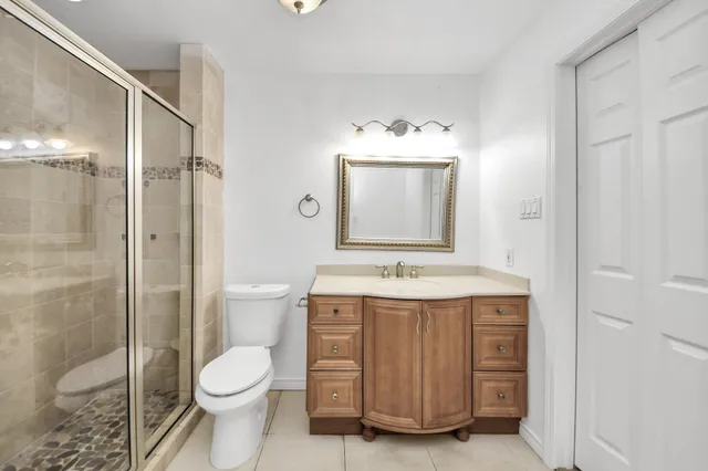 a bathroom with a toilet a sink and shower