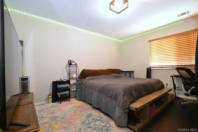 a bedroom with a bed and dresser