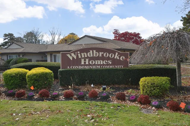 a sign that is sitting in front of house