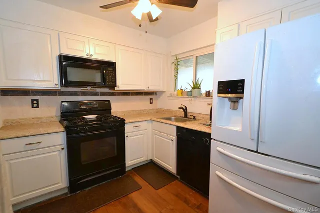 a kitchen with stainless steel appliances a stove microwave and sink