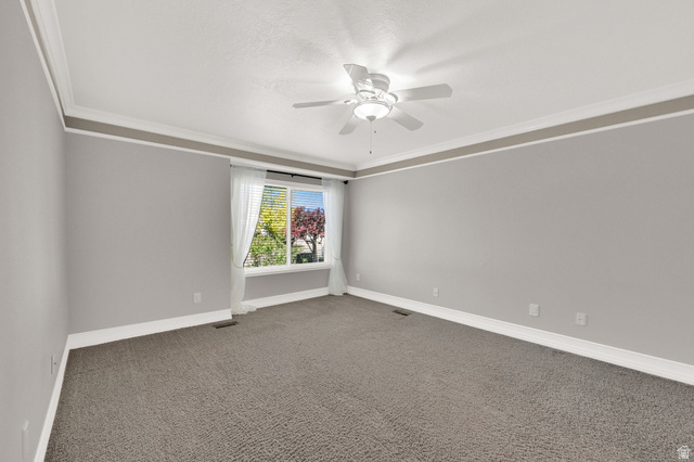 4792 Glasmann Way South Ogden, UT 84403 - Photo 31 of 70 Primary suite bedroom with plush gray carpeting, light gray walls, and white crown molding with a fan/light