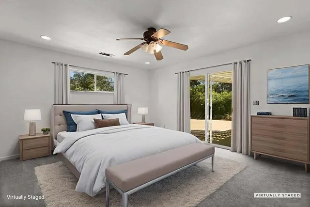 a bedroom with a large bed and a chandelier