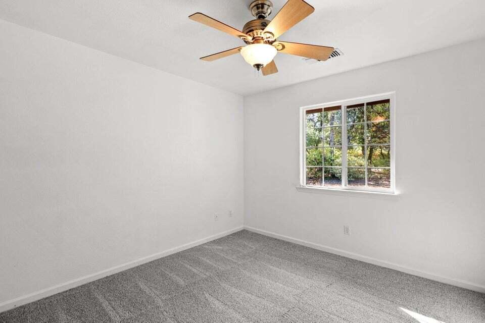 16840 Hawthorne Avenue Anderson, CA 96007 - Photo 23 of 37 an empty room with a window and a fan