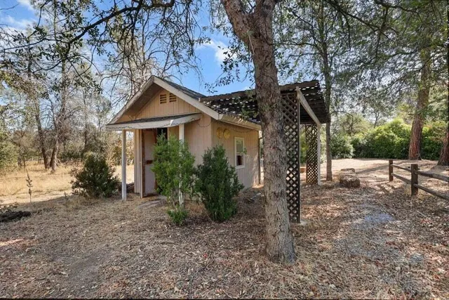 a view of a house with a tree in the yard