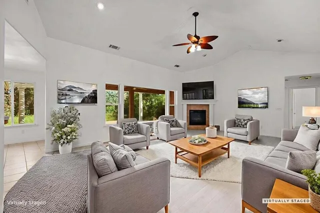 a living room with furniture potted plant and a window