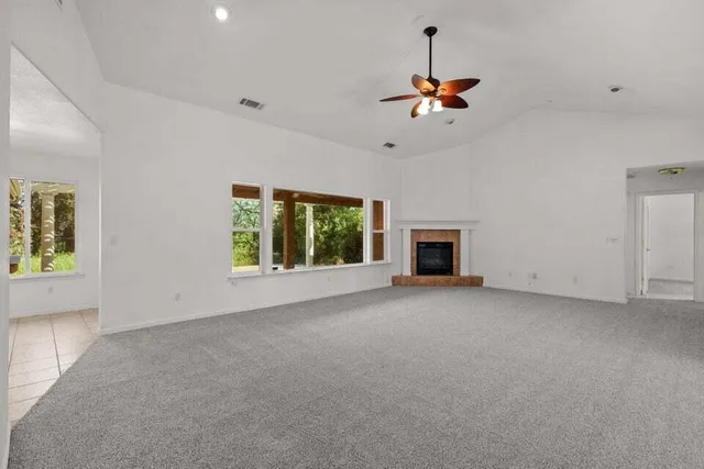 a view of a livingroom with a ceiling fan and window