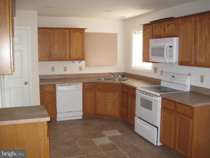 290 Ruebuck Road Clear Brook, VA 22624 - Photo 18 of 28 a kitchen with a stove sink and cabinets