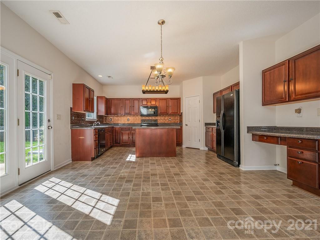 65 Wildbriar Road, Unit 49 Fletcher, NC 28732 - Photo 13 of 43 a kitchen with stainless steel appliances granite countertop a refrigerator and a stove top oven