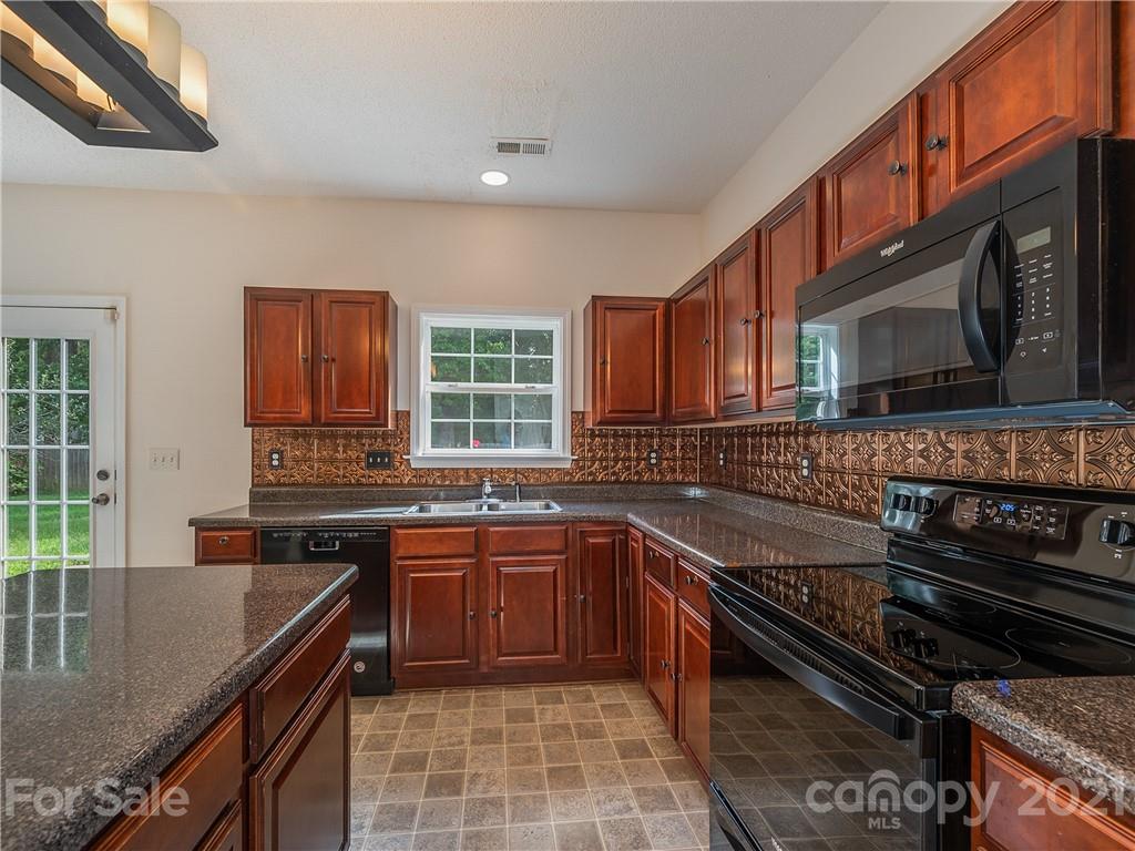 65 Wildbriar Road, Unit 49 Fletcher, NC 28732 - Photo 14 of 43 a kitchen with stainless steel appliances granite countertop a stove sink and cabinets