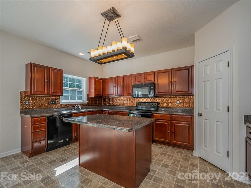 65 Wildbriar Road, Unit 49 Fletcher, NC 28732 - Photo 15 of 43 a kitchen with stainless steel appliances granite countertop a sink a stove and a refrigerator