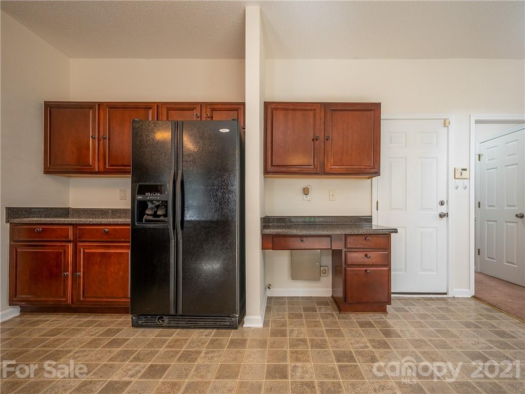 65 Wildbriar Road, Unit 49 Fletcher, NC 28732 - Photo 16 of 43 a kitchen with stainless steel appliances granite countertop a refrigerator and a sink