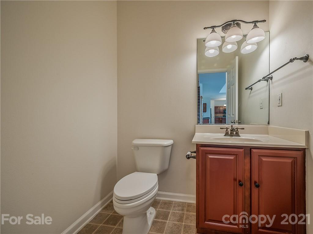 65 Wildbriar Road, Unit 49 Fletcher, NC 28732 - Photo 18 of 43 a bathroom with a toilet a sink and mirror