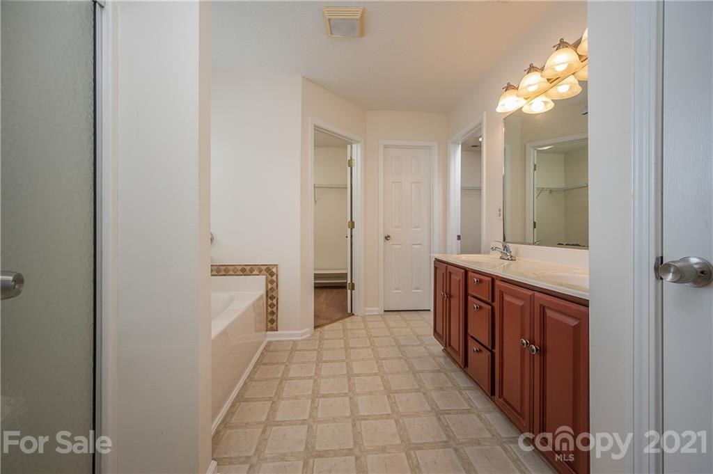 65 Wildbriar Road, Unit 49 Fletcher, NC 28732 - Photo 25 of 43 a bathroom with sink a mirror and a shower