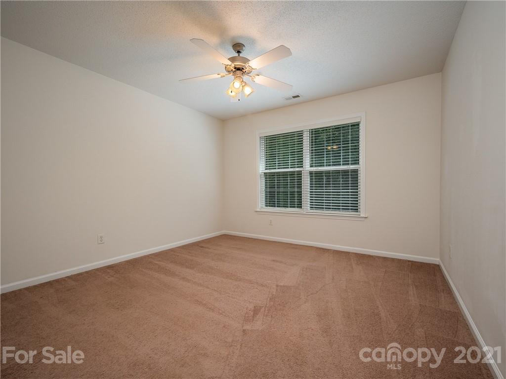 65 Wildbriar Road, Unit 49 Fletcher, NC 28732 - Photo 33 of 43 an empty room with chandelier fan and windows