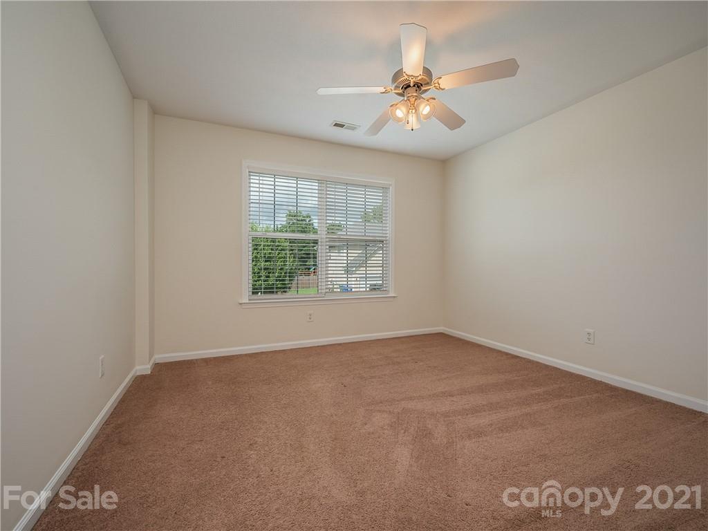 65 Wildbriar Road, Unit 49 Fletcher, NC 28732 - Photo 35 of 43 an empty room with windows and chandelier fan