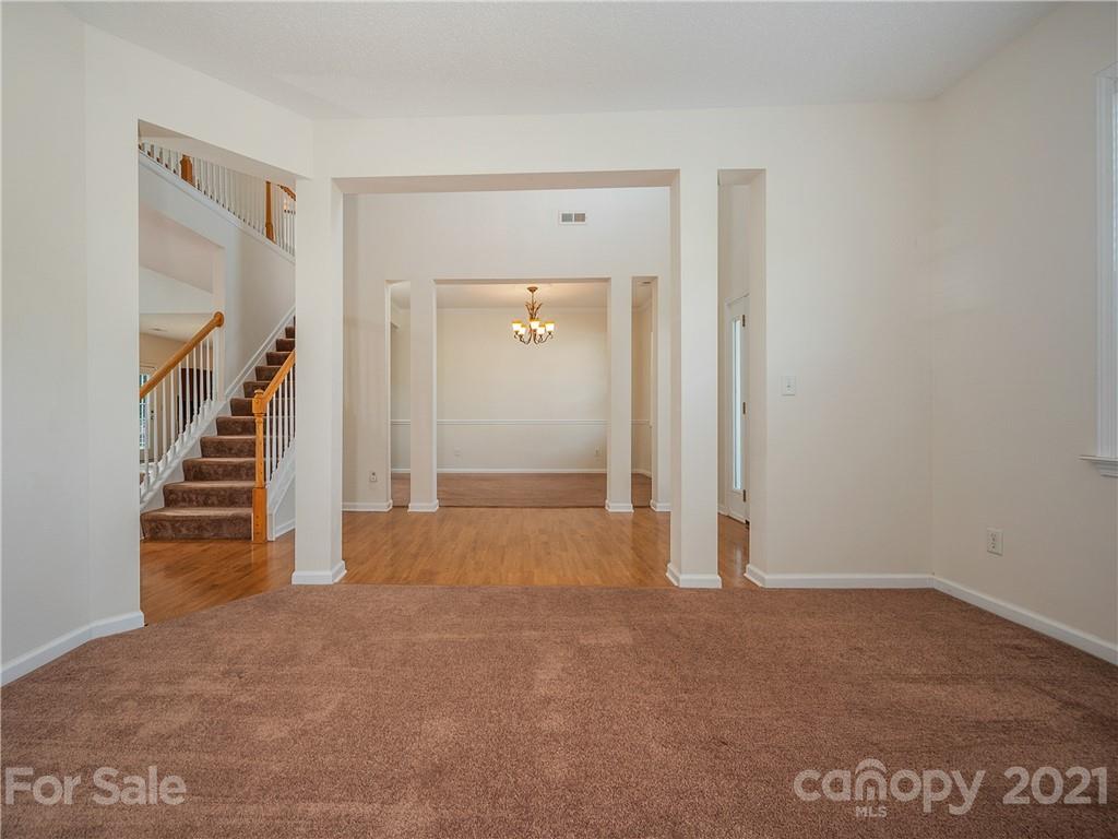 65 Wildbriar Road, Unit 49 Fletcher, NC 28732 - Photo 9 of 43 a view of an empty room with stairs and a hallway