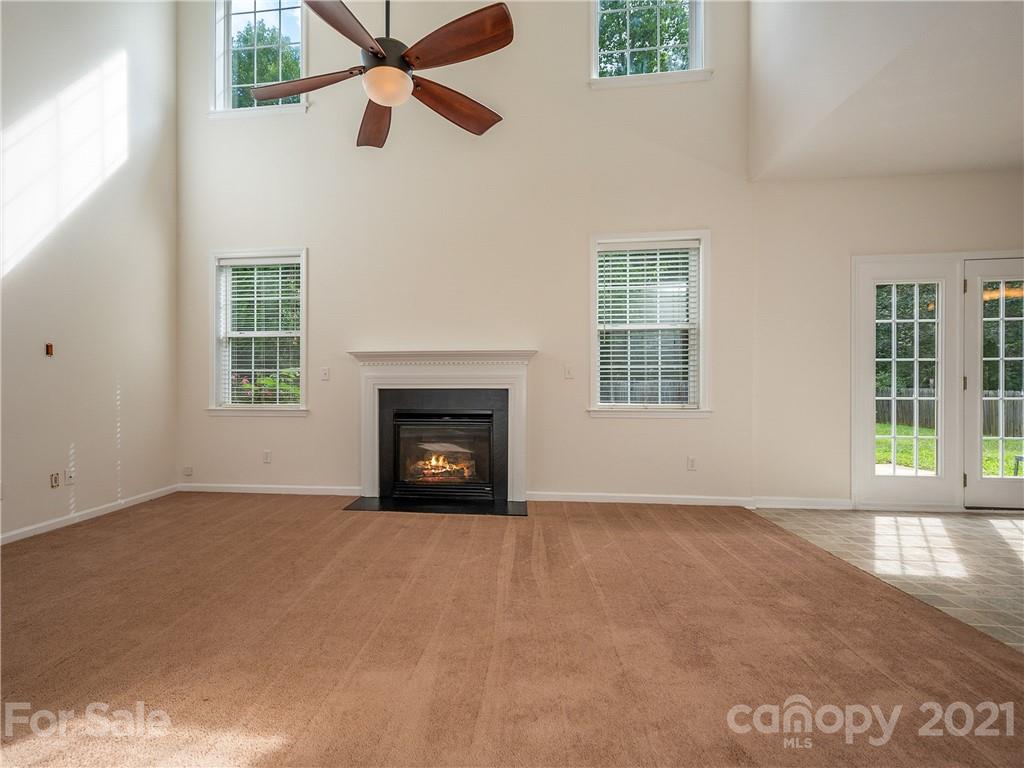 65 Wildbriar Road, Unit 49 Fletcher, NC 28732 - Photo 10 of 43 an empty room with windows and fireplace