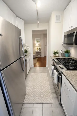 a kitchen with a sink appliances and cabinets