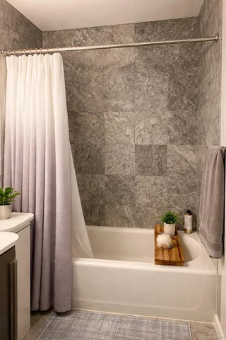 a bathroom with a bathtub and shower