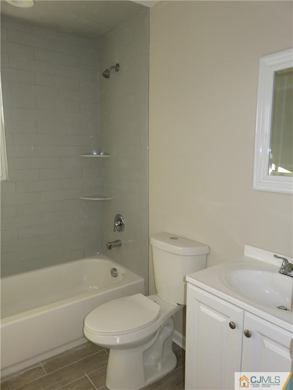 7 Roger Road Edison, NJ 08817 - Photo 11 of 14 a bathroom with a granite countertop toilet a sink and bathtub
