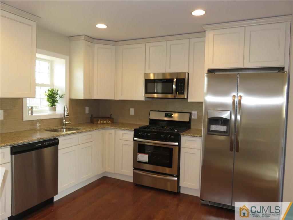 7 Roger Road Edison, NJ 08817 - Photo 4 of 14 a kitchen with a sink stainless steel appliances and cabinets