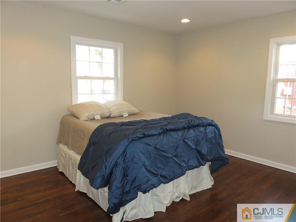 7 Roger Road Edison, NJ 08817 - Photo 8 of 14 a bed sitting in a bedroom next to a window