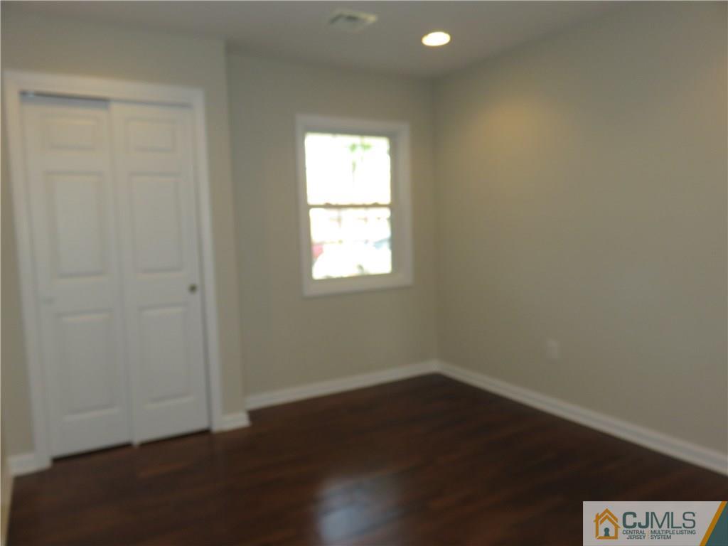 7 Roger Road Edison, NJ 08817 - Photo 10 of 14 an empty room with wooden floor and windows