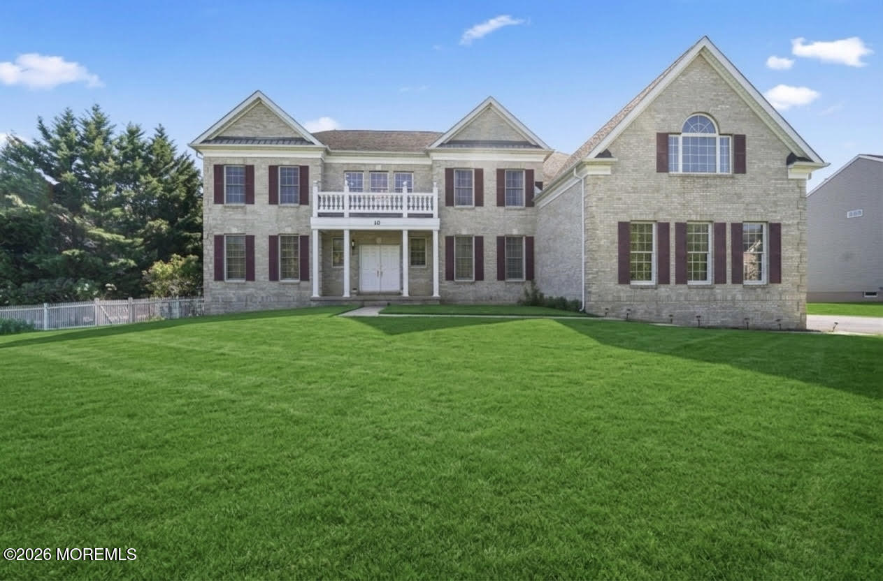10 Rockingham Court Manalapan, NJ 07726 - Photo 1 of 91 a front view of a house with a yard and trees