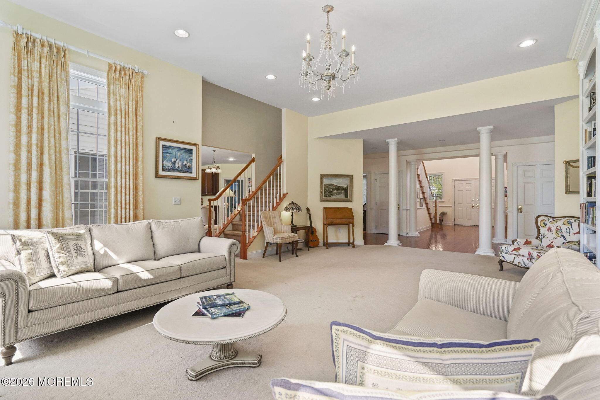 10 Rockingham Court Manalapan, NJ 07726 - Photo 14 of 91 a living room with furniture and a chandelier