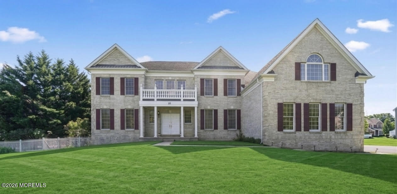 10 Rockingham Court Manalapan, NJ 07726 - Photo 2 of 91 a front view of a house with a yard