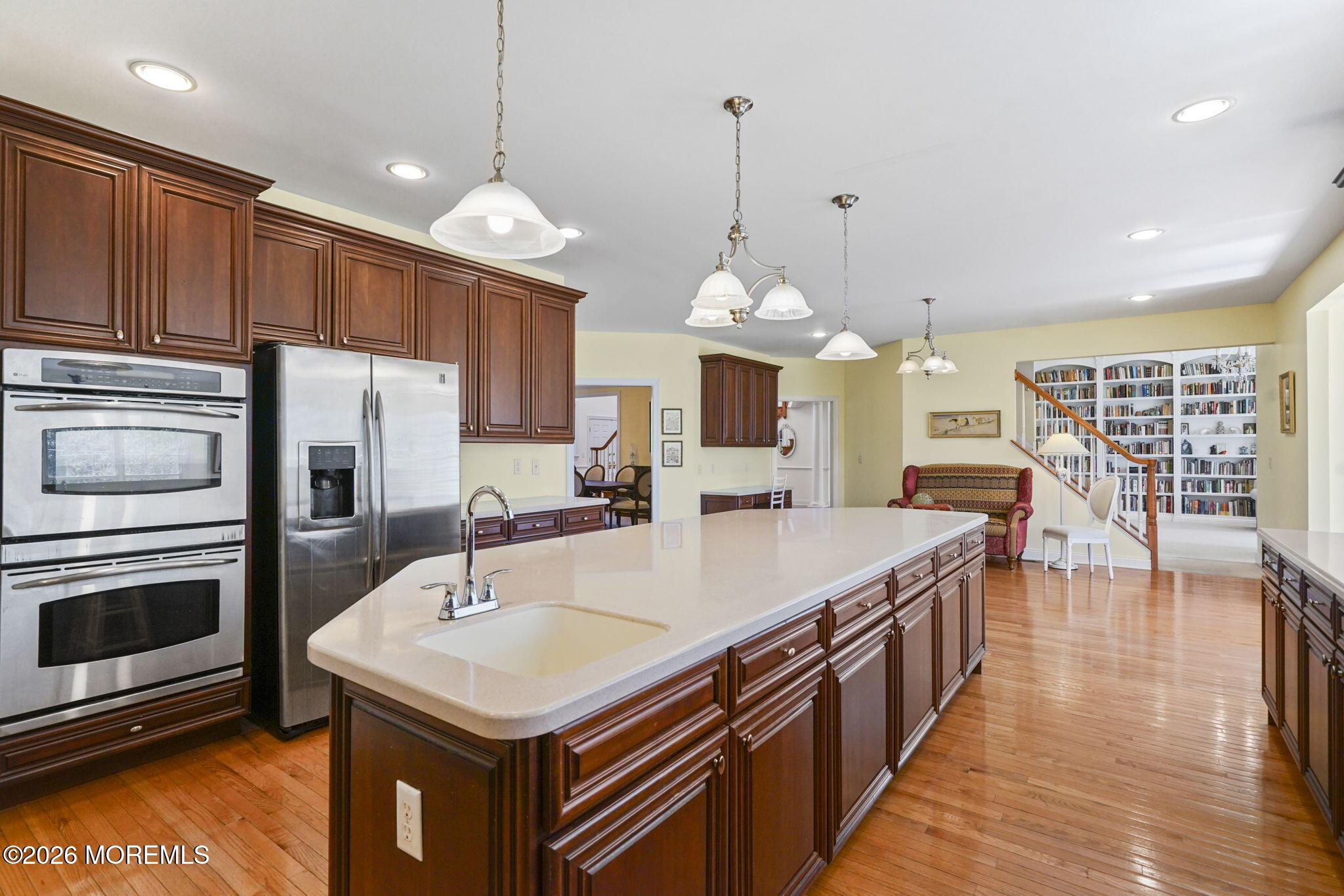 10 Rockingham Court Manalapan, NJ 07726 - Photo 23 of 91 a large kitchen with kitchen island a stove a sink a center island and wooden floor