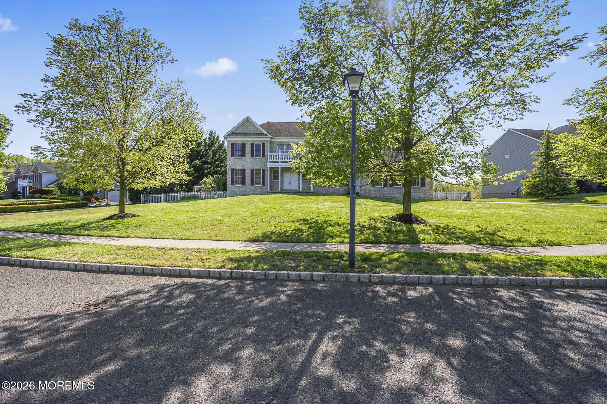 10 Rockingham Court Manalapan, NJ 07726 - Photo 3 of 91 a view of a house with a yard and a large tree