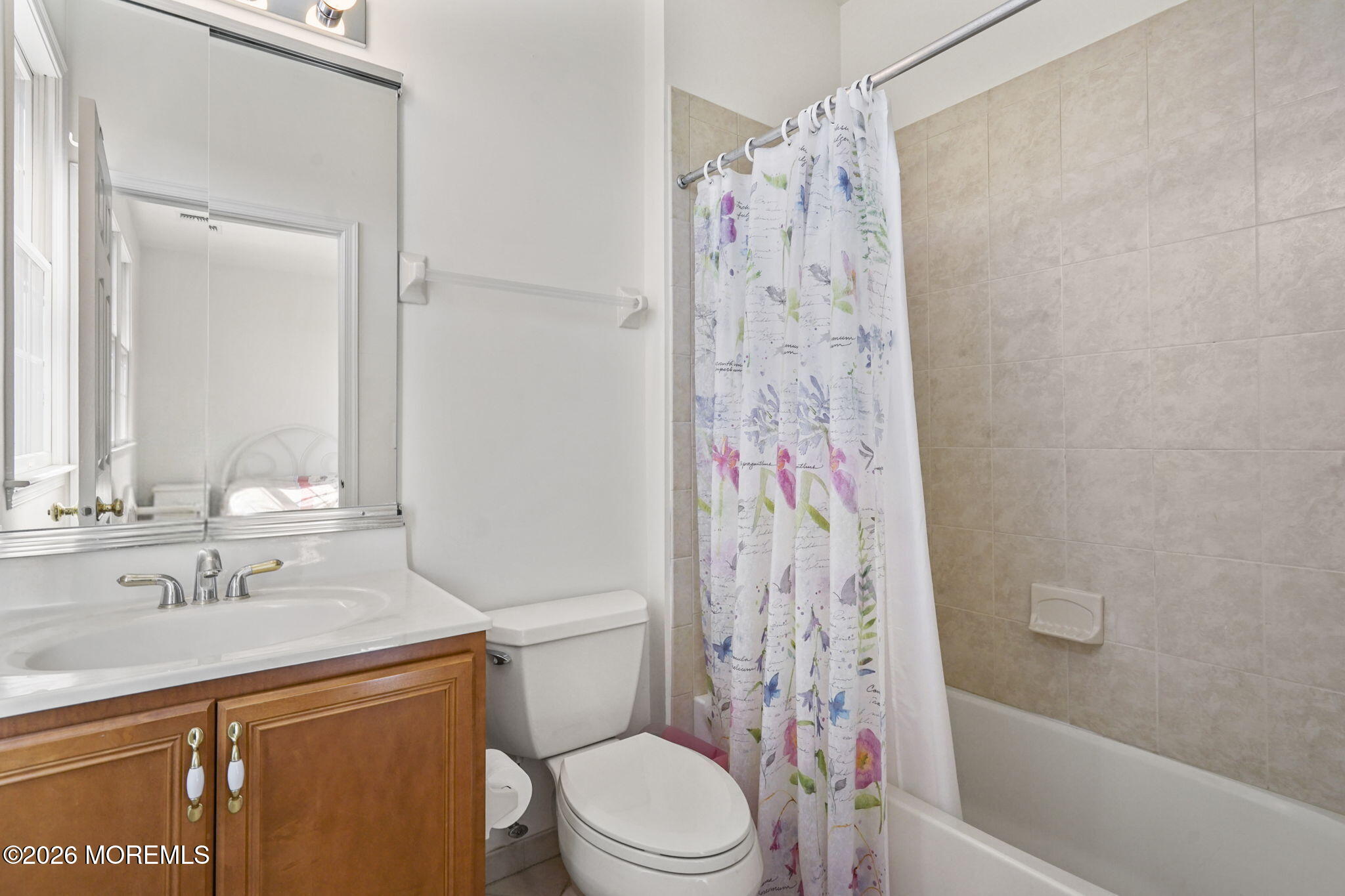 10 Rockingham Court Manalapan, NJ 07726 - Photo 53 of 91 a bathroom with a sink a toilet and shower curtain
