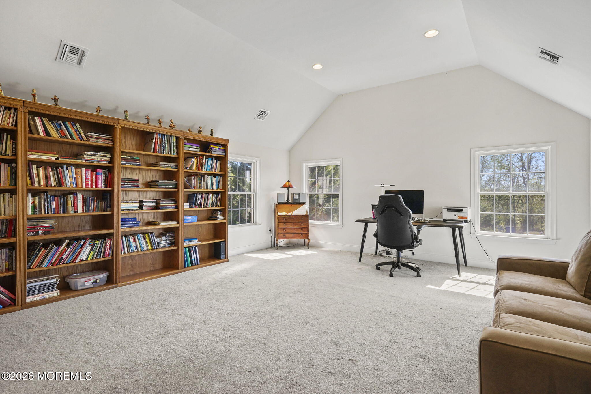 10 Rockingham Court Manalapan, NJ 07726 - Photo 57 of 91 a view of a livingroom with furniture and a bookshelf