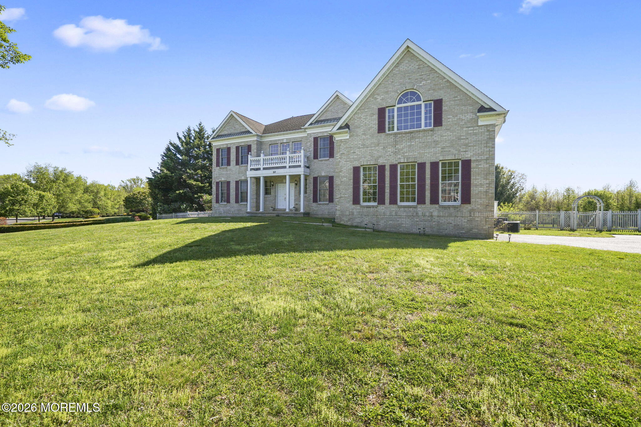 10 Rockingham Court Manalapan, NJ 07726 - Photo 73 of 91 a front view of a house with a yard