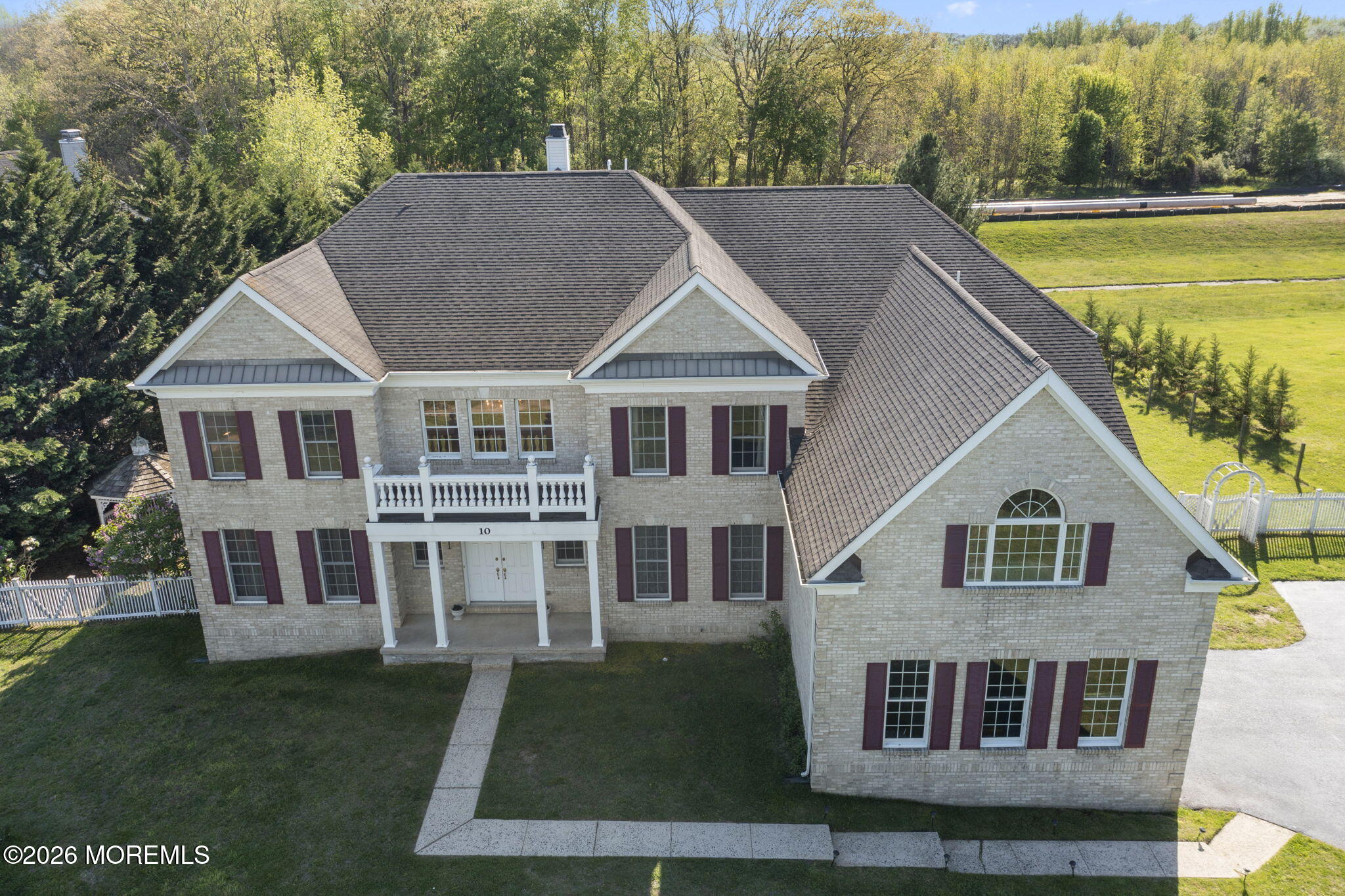10 Rockingham Court Manalapan, NJ 07726 - Photo 75 of 91 a aerial view of a house next to a yard with plants and trees