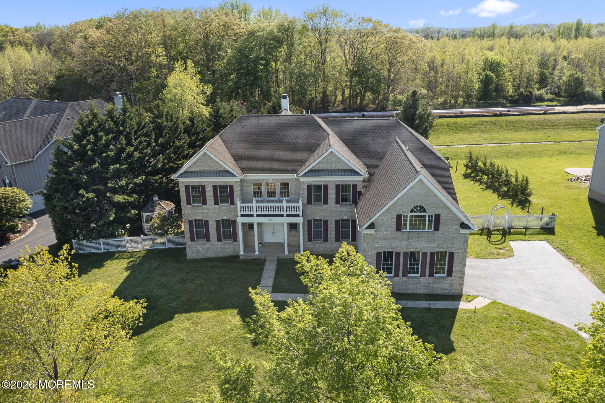 10 Rockingham Court Manalapan, NJ 07726 - Photo 77 of 91 a aerial view of a house with swimming pool next to a yard