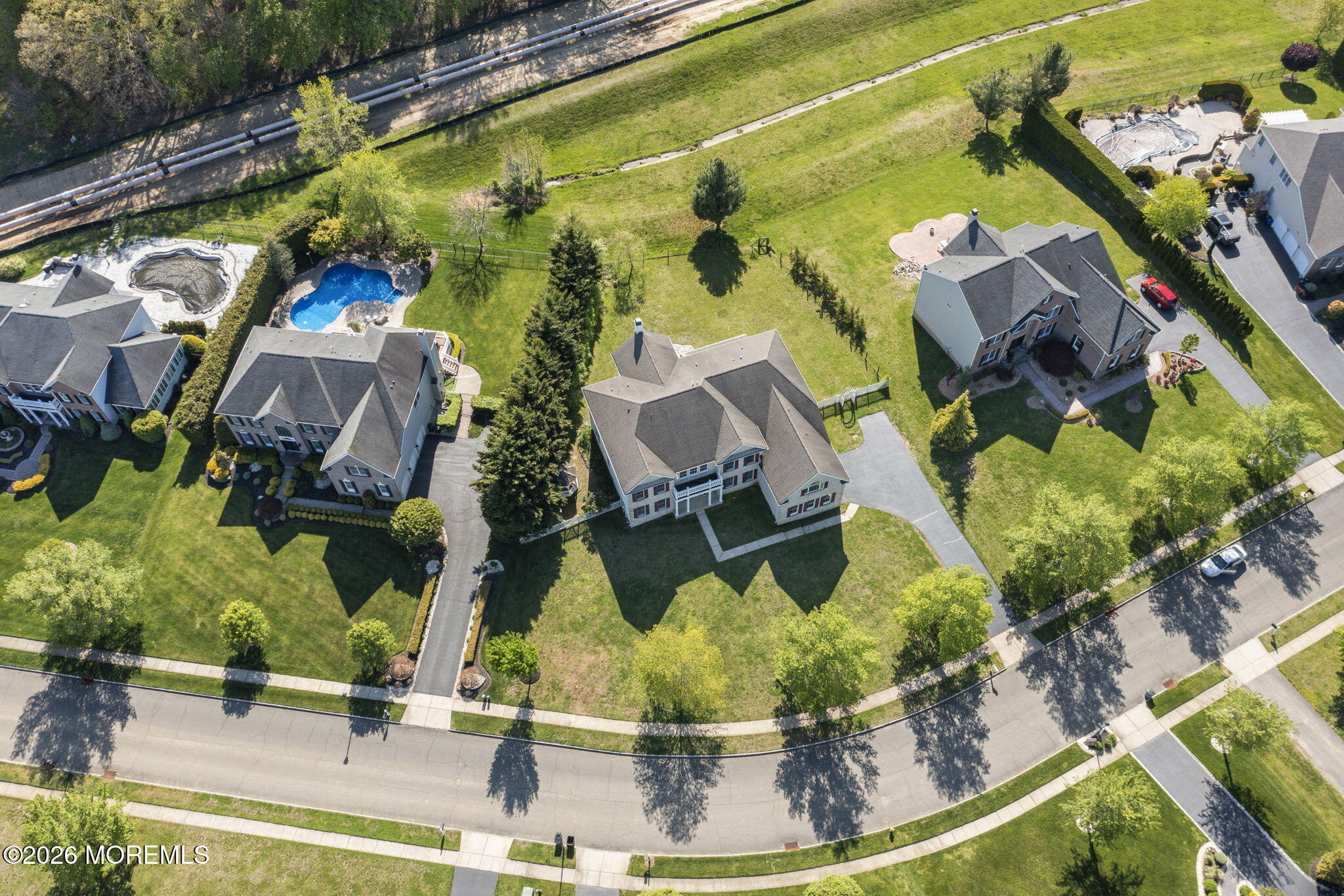 10 Rockingham Court Manalapan, NJ 07726 - Photo 79 of 91 an aerial view of a house with a swimming pool